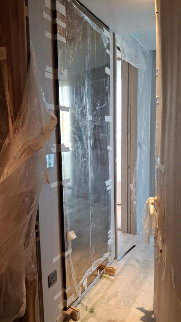 Finished glass door protected with film ahead of handover