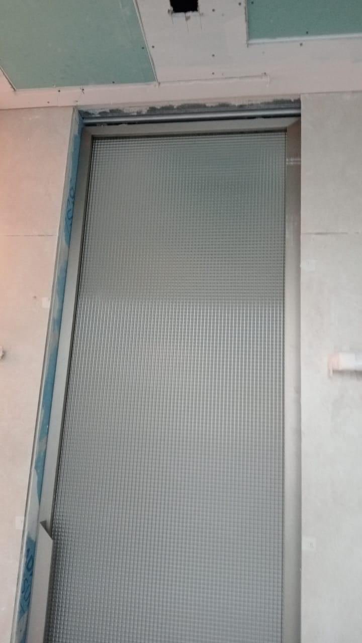 Close-up of reeded glass door frame installation