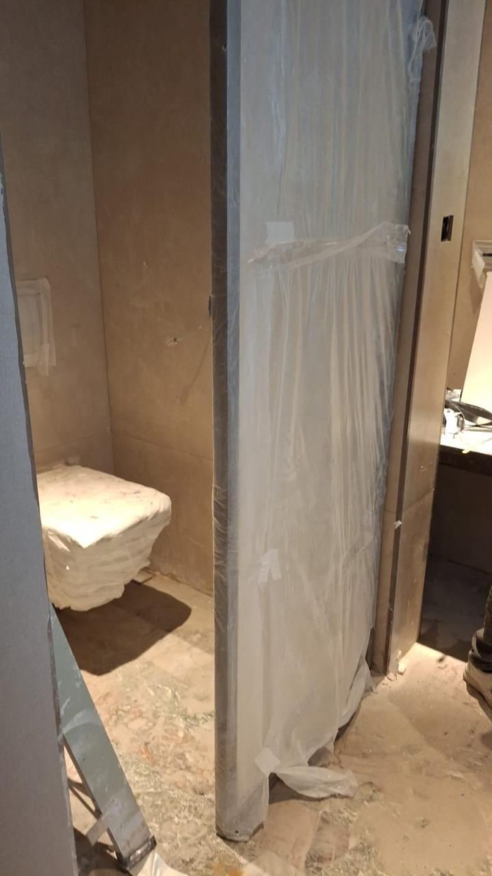 WC door and glass partition installation in progress